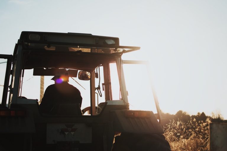 farmer in his tractor out and about on the farm